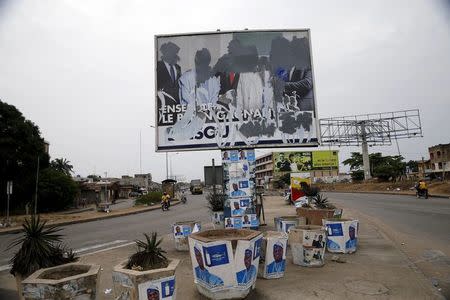 A defaced billboard is seen along a road, a day before Benin's presidential election in Cotonou, March 5, 2016. REUTERS/Akintunde Akinleye