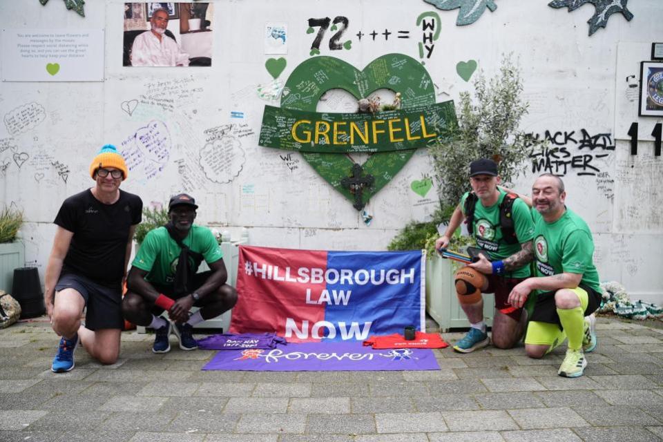 The Northern Echo: Mik Parkin (second right) with supporters after finishing his charity run for the Hillsborough Law campaign, from Liverpool to London at Grenfell Tower