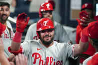 Philadelphia Phillies designated hitter Kyle Schwarber celebrates in the dugout after hitting a two-run home run in the sixth inning of a baseball game against the Atlanta Braves Monday, Sept. 18, 2023. (AP Photo/John Bazemore)