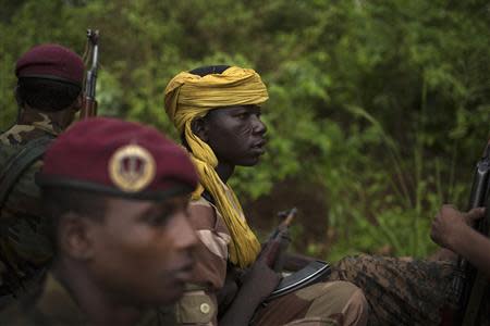 Former Seleka soldiers drive to a village, where residents say was attacked and a mosque burnt the night before by anti-Balaka militiamen, about 25 kilometres (16 miles) from Bambari May 10, 2014. REUTERS/Siegfried Modola
