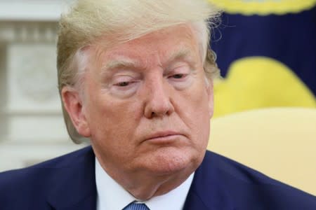 U.S. President Trump listens to reporters questions during meeting with Pakistan’s Prime Minister Khan at the White House in Washington