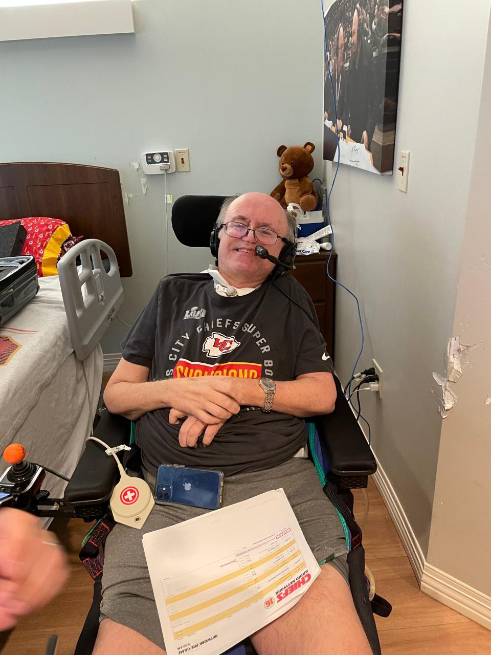 Art Hains sitting in his motorized wheelchair at the Springfield Rehabilitation and Health Center ready for his gameday studio host duties for the Kansas City Chiefs.