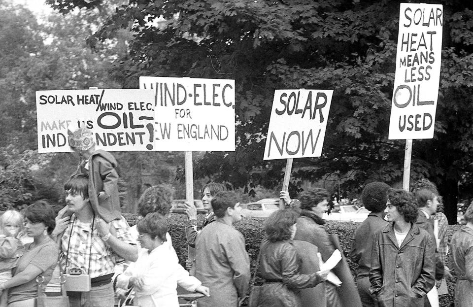 Demonstrators hold signs outside of the Slocum estate on Bellevue Avenue during a visit from President Gerald Ford in this photo from Aug. 30, 1975.