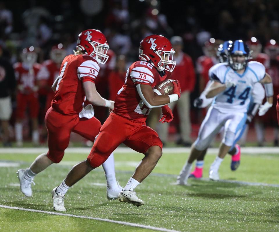 North Rockland quarterback Tyler Italiano (4) hands off to Freddy Vasquez (22) during their 23-16 win over Suffern in football action at Suffern Middle School in Suffern on Friday, September 23, 2022.