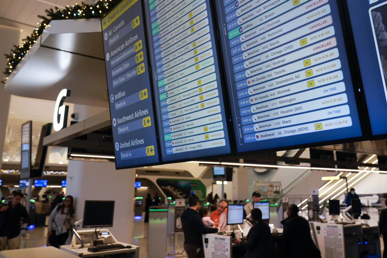 A display shows flights, many delayed, at LaGuardia Airport in New York, Wednesday, Jan. 11, 2023. (AP Photo/Seth Wenig)