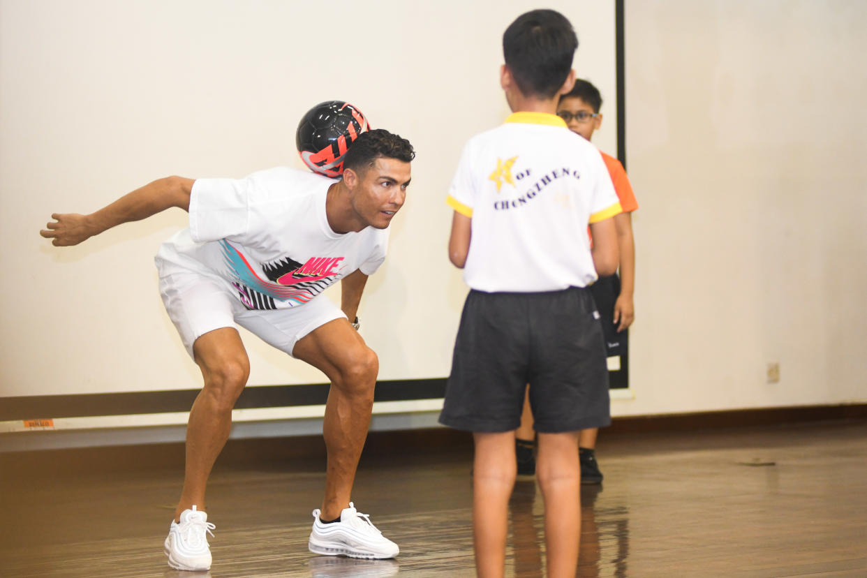 Football superstar Cristiano Ronaldo displaying his deft ball-control skills during his visit to Yumin Primary School on 4 July 2019. (PHOTO: Stefanus Ian/Yahoo News Singapore)