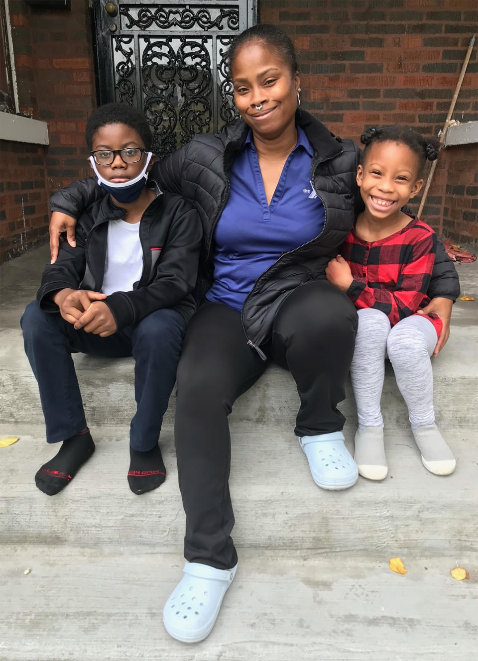 Image: Tahiti Hamer and her children in front of their home in the South Shore neighborhood in Chicago. (Courtesy Tahiti Hamer)