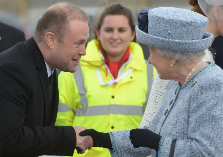 Queen Elizabeth II (R) is welcomed by Malta's Prime Minister Joseph Muscat on her arrival on the island on November 26, 2015