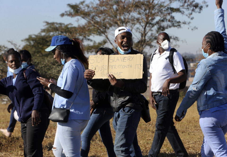 Nurses take part in a protest at a government hospital in Harare, Monday, July, 6, 2020. Thousands of nurses working in public hospitals stopped reporting for work in mid-June, part of frequent work stoppages by health workers who earn less than $50 a month and allege they are forced to work without adequate protective equipment. On Monday, dozens of nurses wearing masks and their white and blue uniforms gathered for protests at some of the country’s biggest hospitals in the capital, Harare, and the second-largest city of Bulawayo.(AP Photo/Tsvangirayi Mukwazhi)