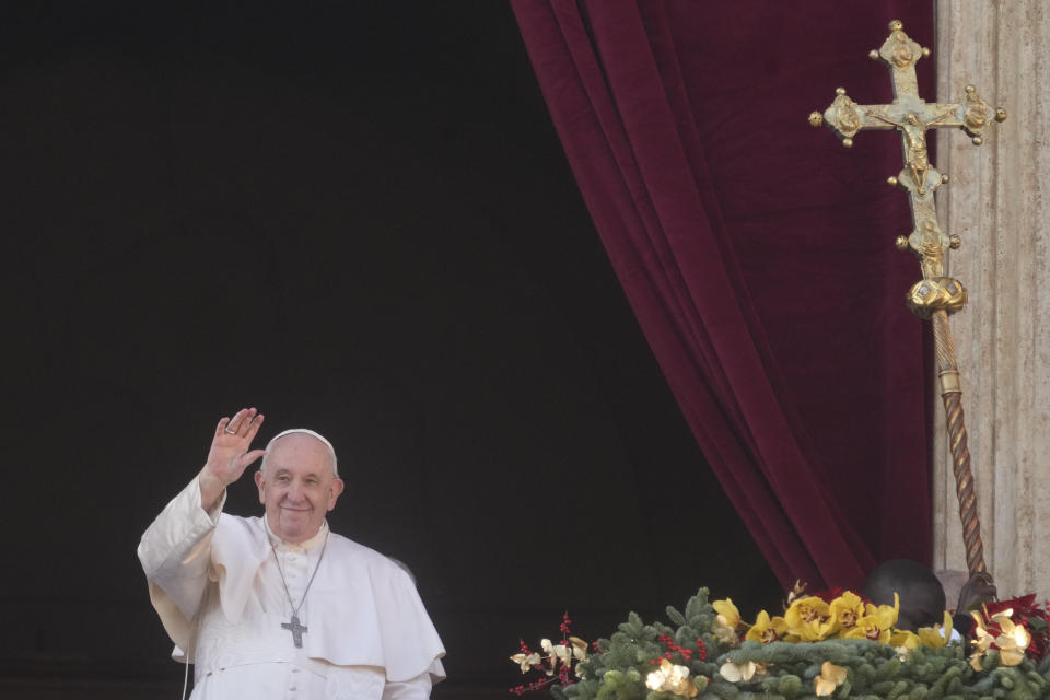 Pope Francis waves to faithful as he delivers the Urbi et Orbi (Latin for 'to the city and to the world' ) Christmas' day blessing from the main balcony of St. Peter's Basilica at the Vatican, Sunday, Dec. 25, 2022. (AP Photo/Gregorio Borgia)