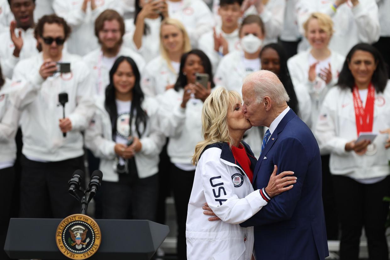 U.S. President Joe Biden and U.S. first lady Jill Biden kiss in front of members of Team USA on the South Lawn at the White House on May 4, 2022, in Washington, DC.