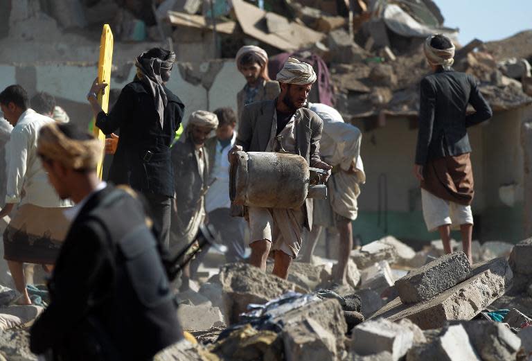 Yemenis search the rubble of buildings destroyed during Saudi air strikes against Huthi rebels near Sanaa Airport which killed at least 13 civilians, March 26, 2015