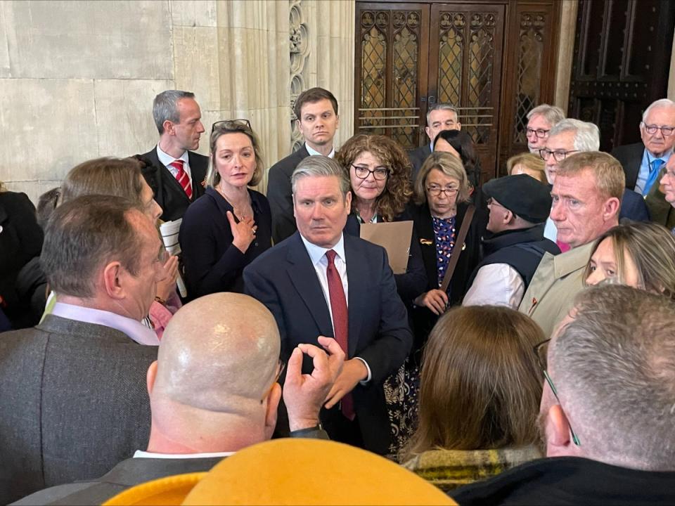 Victims of the infected blood scandal and their relatives surround Sir Keir Starmer in Westminster Hall, February 2024 (Samuel Montgomery/PA Wire)