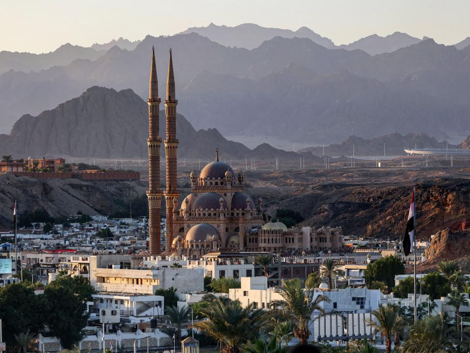 A view of buildings in front of a mountain range