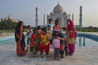 A group of Indians who visited the Taj Mahal monument that was Wednesday reopened to public after the lockdown to curb the spread of coronavirus gather to get photographed in Agra, India, Wednesday, June 16, 2021. (AP Photo)