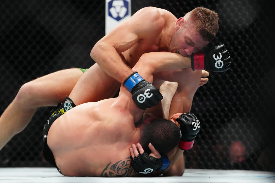 Jul 8, 2023; Las Vegas, Nevada, USA; Robert Whittaker (red gloves) fights Dricus Du Plessis (blue gloves) during UFC 290 at T-Mobile Arena. Mandatory Credit: Stephen R. Sylvanie-USA TODAY Sports