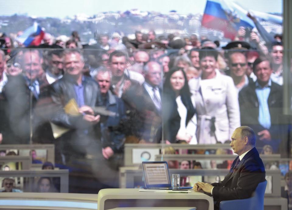 FILE - Russian President Vladimir Putin listens to a question of residents of Sevastopol, Crimea, Thursday, April 17, 2014. The Crimean Peninsula's balmy beaches have been vacation spots for Russian czars and has hosted history-shaking meetings of world leaders. And it has been the site of ethnic persecutions, forced deportations and political repression. Now, as Russia’s war in Ukraine enters its 18th month, the Black Sea peninsula is again both a playground and a battleground. (AP Photo/RIA Novosti, Alexei Nikolsky, Presidential Press Service, File)