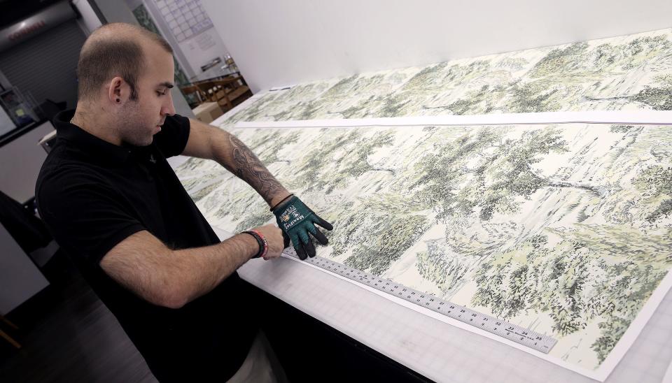 Nick Magarelli, Manalapan, trims wallpaper at Tempaper Monday, July 18, 2022. The Brick business sells peel-and-stick wallpaper in a variety of patterns and prices.