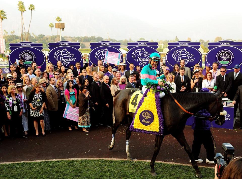 Jockey Mike Smith celebrates atop Zenyatta after the horse's win in the 2009 Breeders' Cup Classic.