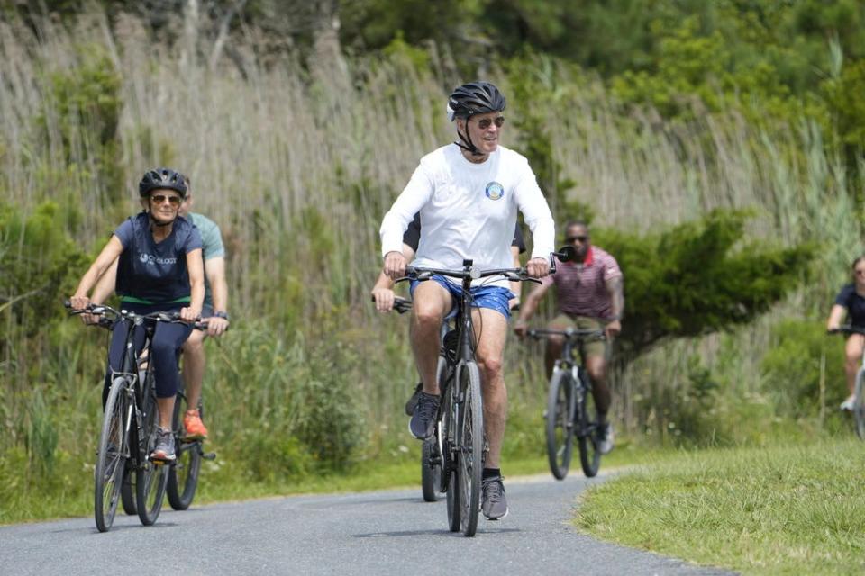 President Joe Biden and first lady Jill Biden ride their bikes on a bike path at Gordons Pond near Rehoboth Beach on Tuesday, Aug. 1, 2023.