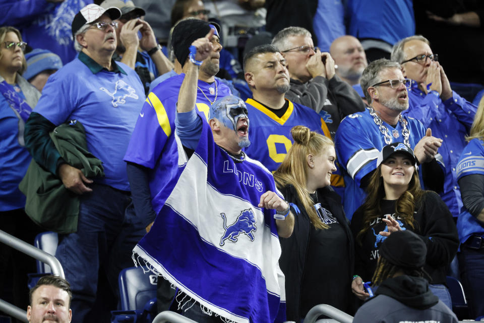 Detroit Lions fans cheer during the second half of an NFL wild-card playoff football game against the Los Angeles Rams, Sunday, Jan. 14, 2024, in Detroit. (AP Photo/Duane Burleson)