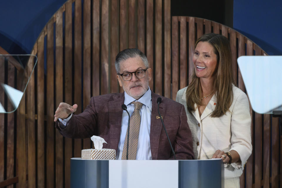 Dan and Jennifer Gilbert speak during a press conference at the Book Tower in Detroit, Wednesday, Sept. 6, 2023, to announce a nearly $375 million philanthropic effort to fight strokes and research cures for neurofibromatosis. (David Guralnick/Detroit News via AP)