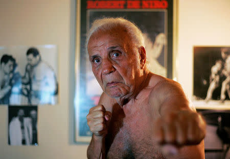 FILE PHOTO: Former middleweight boxing champion Jake LaMotta poses in New York October 28, 2009. LaMotta learned to fight with an ice pick in his hand in a Bronx schoolyard, battering all the way in later life to a world middleweight title in an era of 15-round fights. REUTERS/Teddy Blackburn/File Photo