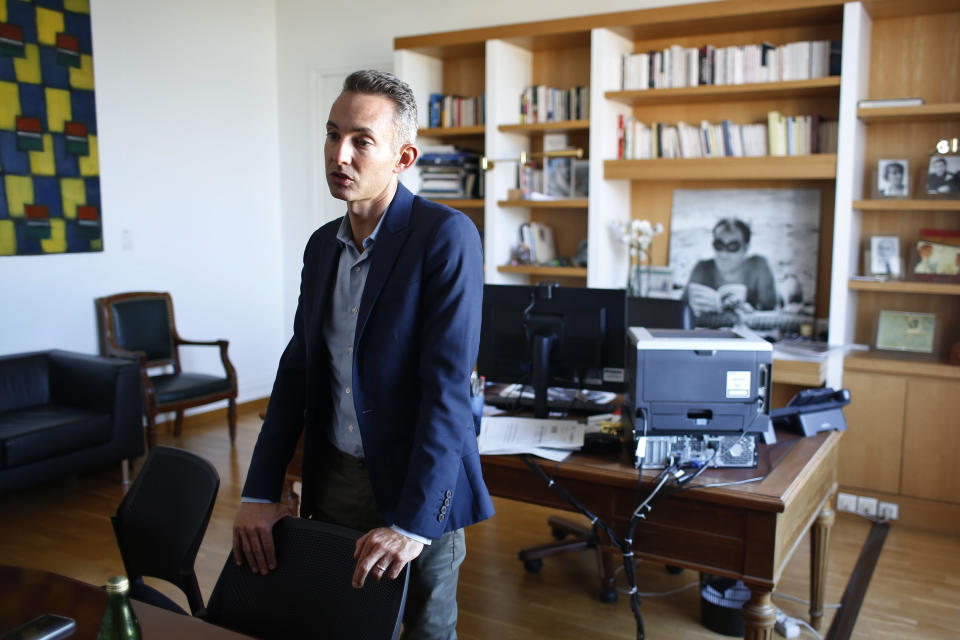 In this Tuesday, Sept. 11, 2018 photo, Paris Deputy Mayor Ian Brossat, in charge of housing, poses for a photo in his office during an interview in Paris. The spectacular growth of Airbnb in Paris, the top worldwide location for the internet giant is also raising alarms in the French capital. Some Parisians and officials at City Hall blame the site for driving Parisian families out of the city center, leading to school closures and concerns that the French capital is losing its life and charms. (AP Photo/Thibault Camus)