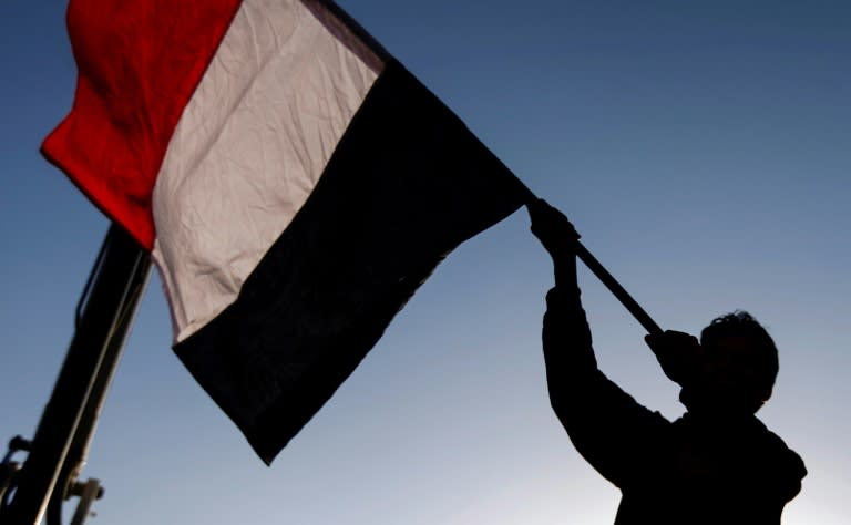 A Yemeni waves a national flag during a rally celebrating the death of Yemeni ex-president Ali Abdullah Saleh a day after he was killed, in the capital Sanaa on December 5, 2017