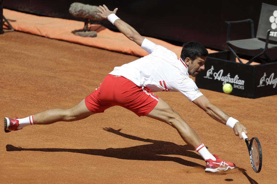 Serbia's Novak Djokovic returns the ball to Greece's Stefanos Tsitsipas during their quarter-final match at the Italian Open tennis tournament, in Rome, Saturday, May 15, 2021. (AP Photo/Gregorio Borgia)