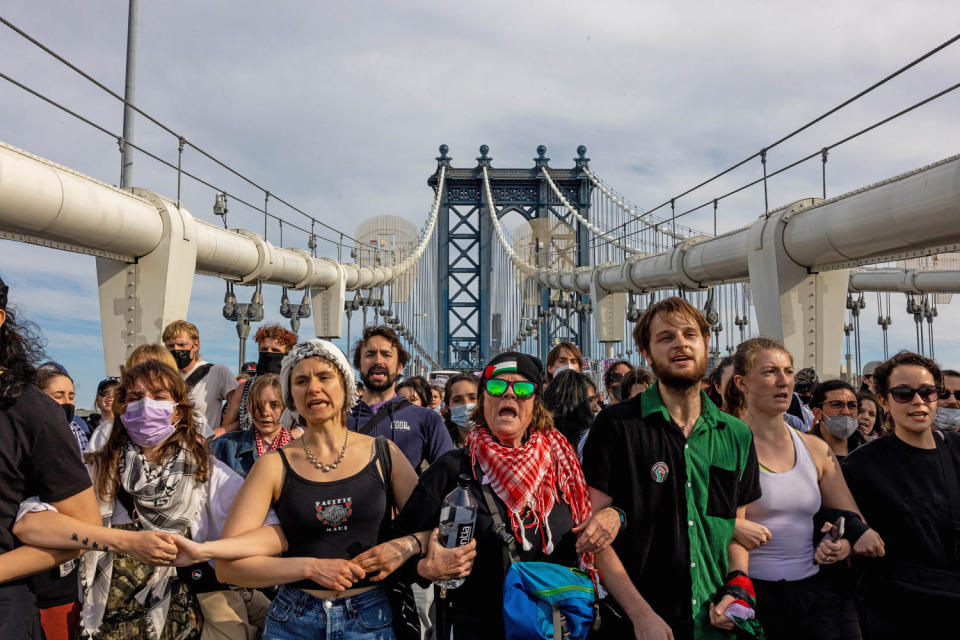 Pro-Palestinian demonstrators join arms as they block traffic on the Manhattan Bridge. (Alex Kent / Getty Images)