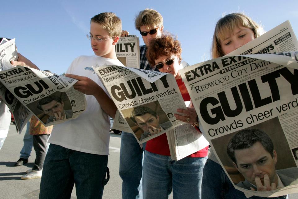 People read about the verdict in the Scott Peterson murder trial November 12, 2004 in Redwood City, California.