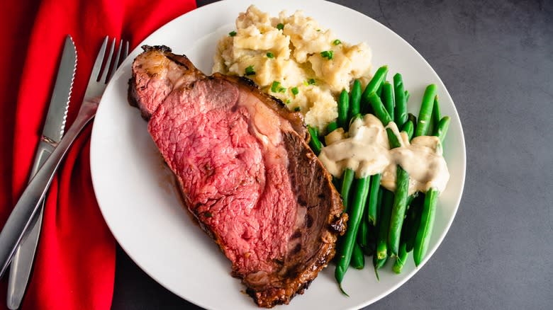 Prime rib with beans and mashed potatoes