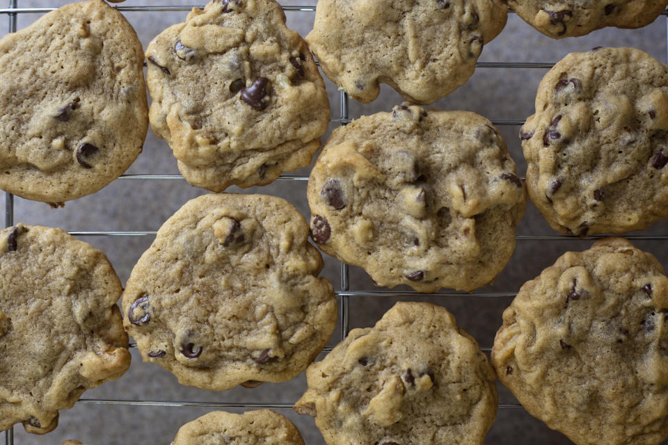 Homemade chocolate chip cookies on a wire rack.