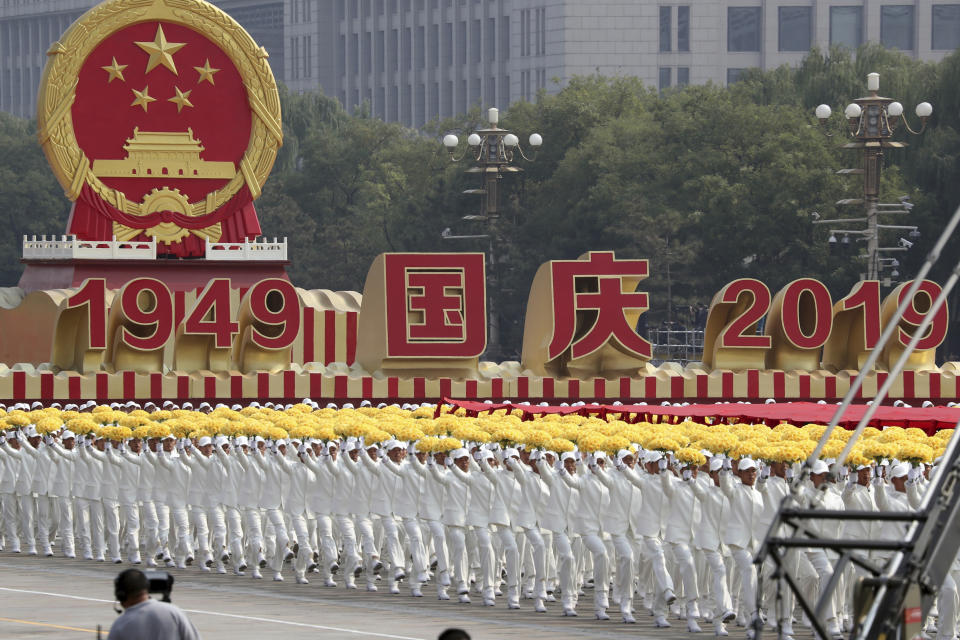 Participants march during the the celebration to commemorate the 70th anniversary of the founding of Communist China in Beijing, Tuesday, Oct. 1, 2019. (AP Photo/Ng Han Guan)