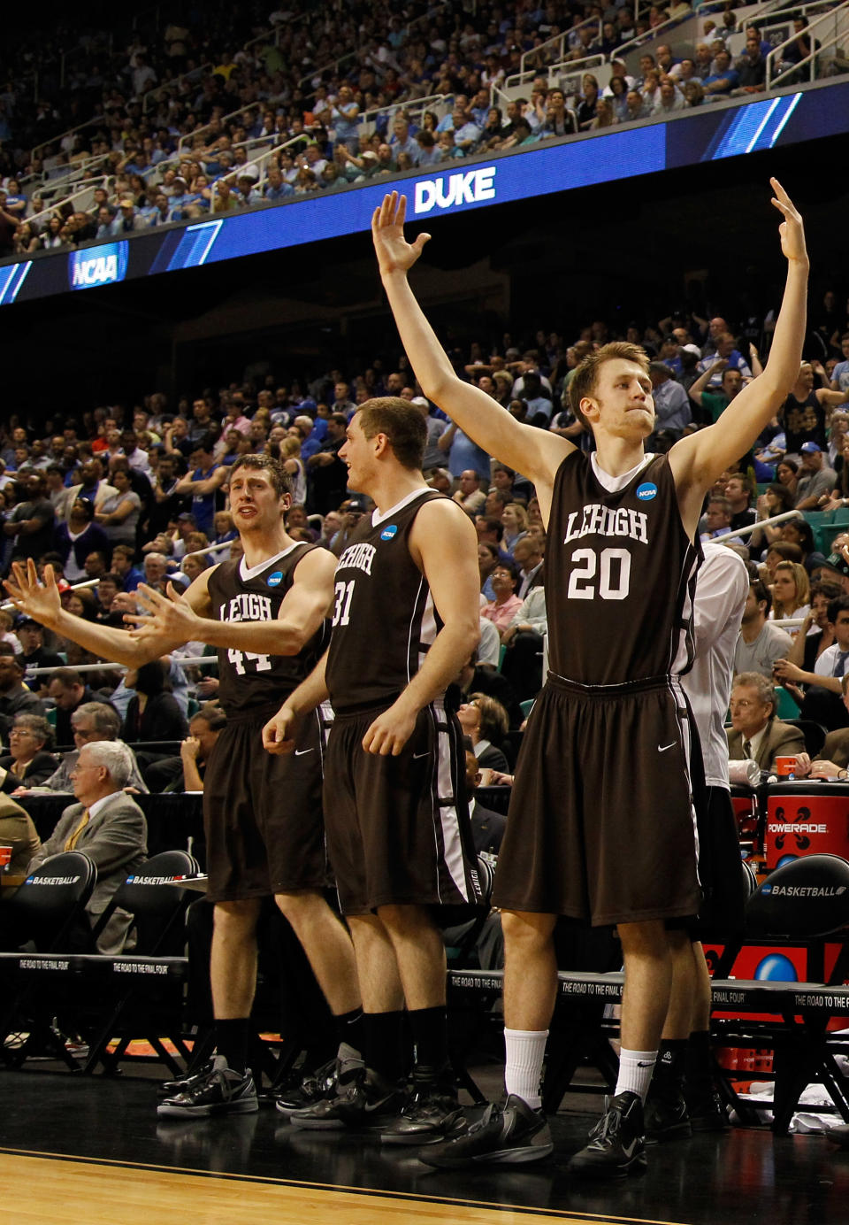 GREENSBORO, NC - MARCH 16: (R-L) Holden Greiner #20, Justin Maneri #31 and Jordan Hamilton #44 of the Lehigh Mountain Hawks celebrate late in the second half before the Mountain Hawks defeat the Duke Blue Devils during the second round of the 2012 NCAA Men's Basketball Tournament at Greensboro Coliseum on March 16, 2012 in Greensboro, North Carolina. (Photo by Mike Ehrmann/Getty Images)