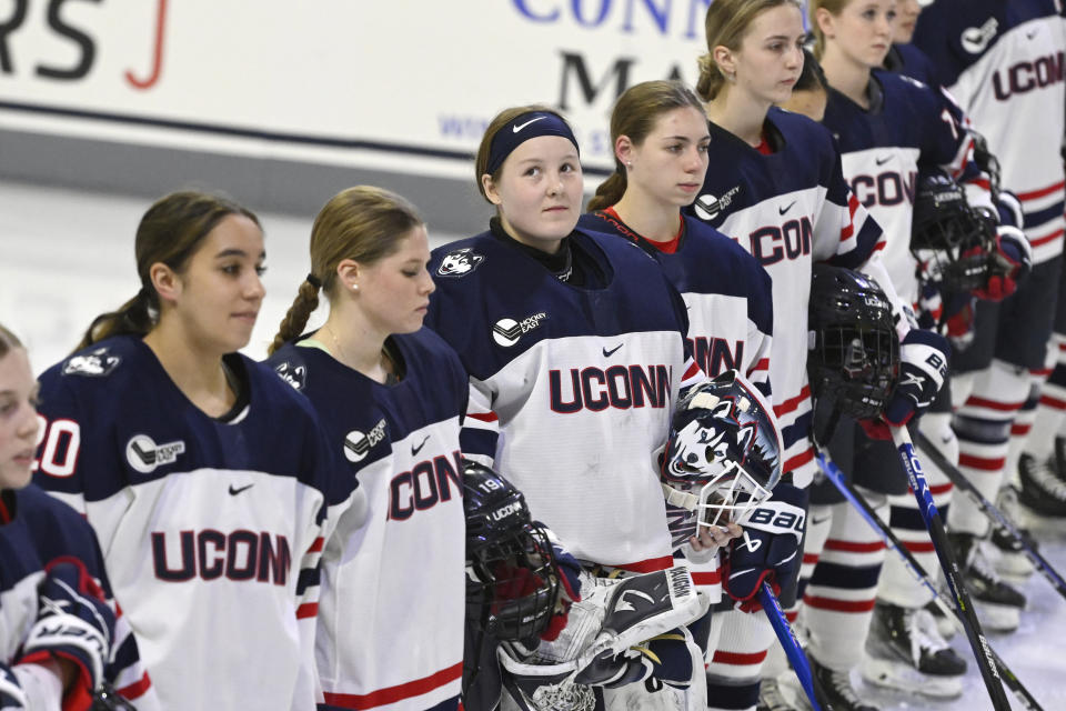 UConn goaltender Megan Warrener, center, looks up during the national anthem, Friday, Jan. 13, 2023, before an NCAA college hockey game at the Toscano Family Ice Forum in Storrs, Conn. (AP Photo/Jessica Hill)