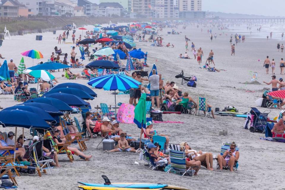 Beachgoers pack the beach in the Cherry Grove section o North Myrtle Beach. On boats, beaches and the boulevards, tourists and residents enjoy the first days of the summer season on the Grand Strand during Memorial Day weekend 2021. May 29, 2021. JASON LEE/MyrtleBeach