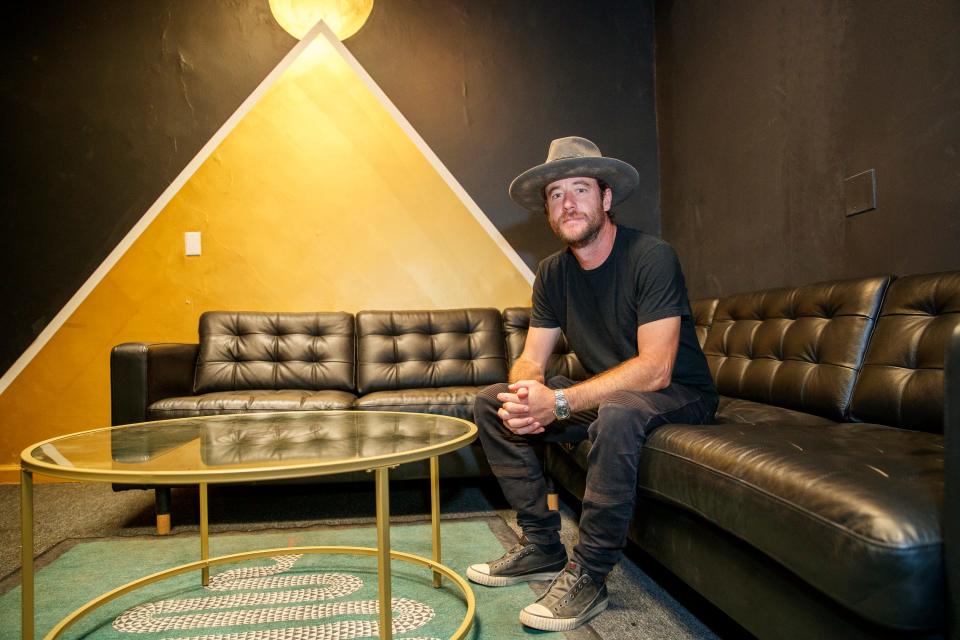 Clark Fyans, AWE Bar President and Operating Manager, sits in the green room at the music venue in Yucca Valley, Calif., on July 29, 2022. 