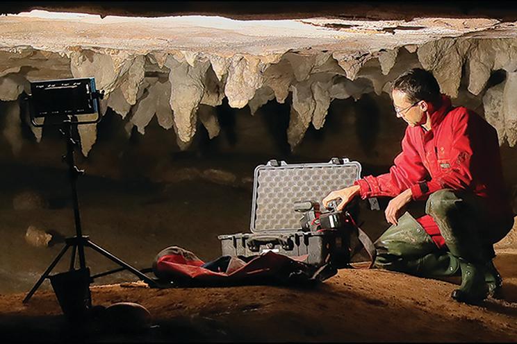 One of the researchers, photographer Stephen Alvarez, with scanning equipment in the cave in Alabama where the Native American carvings were found. The largest carvings are now almost invisible; they were discovered in a detailed three-dimensional photographic model of the cave ceiling.
 (Alan Cressler / Antiquity Journal)