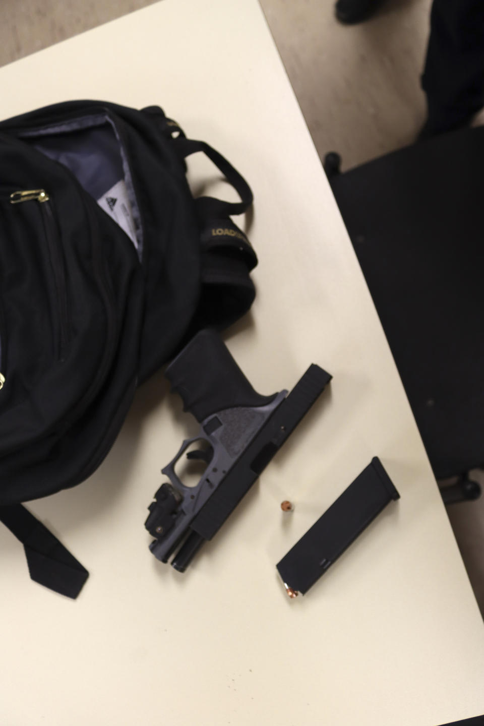 This image taken May 3, 2022, and provided by the Oak Park, Ill., Police Department, shows a gun and ammunition found in a backpack taken from Keyon Robinson outside Oak Park and River Forest High School in Oak Park, Ill. Robinson was a senior at the high school at the time and said he had brought the gun to school to protect himself after an altercation with a relative. Robinson, who said he had no plan to hurt anyone, bought the ghost gun via a gun seller who advertised on the social media site Snapchat. (Oak Park Police Department via AP)