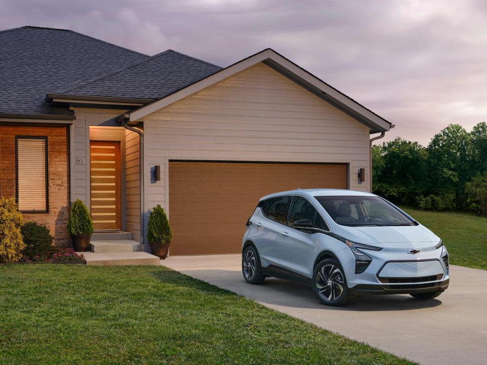 An electric car parked in a driveway.