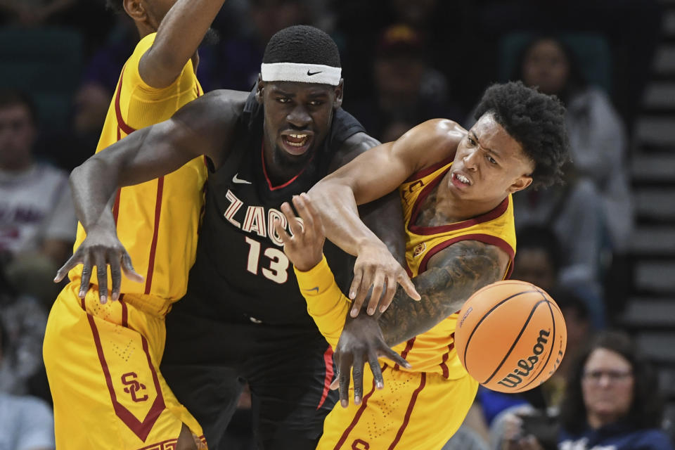 Southern California guard Boogie Ellis, right, steals the ball from Gonzaga forward Graham Ike (13) during the second half of an NCAA college basketball game Saturday, Dec. 2, 2023, in Las Vegas. (AP Photo/Sam Morris)