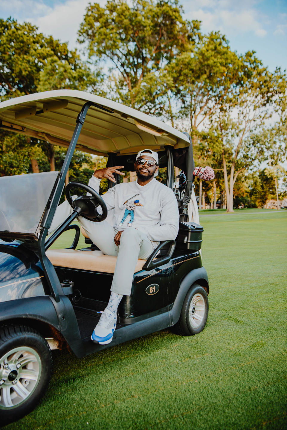 Eastside Golf founder Olajuwon Ajanaku wearing the brand's trademark sweatshirt, which retails for $120