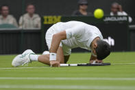 Serbia's Novak Djokovic slips over as he plays Korea's Kwon Soonwoo in a men's first round singles match on day one of the Wimbledon tennis championships in London, Monday, June 27, 2022. (AP Photo/Kirsty Wigglesworth)