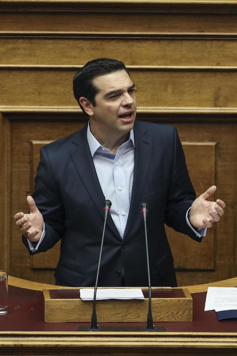 Greece's Prime Minister Alexis Tsipras addresses lawmakers during a parliamentary session in Athens, Saturday, Dec. 10, 2016. Greek parliament votes on 2017 budget, as the country's left-wing government is still negotiating a new series of cost-cutting reforms that are expected to remove protection measures for private sector jobs and distressed mortgage holders. (AP Photo/Yorgos Karahalis)