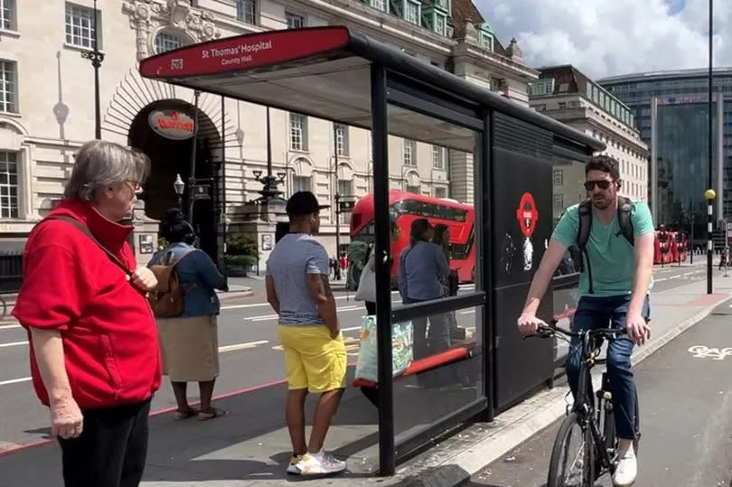 A cyclist and pedestrian at a London floating bus stop