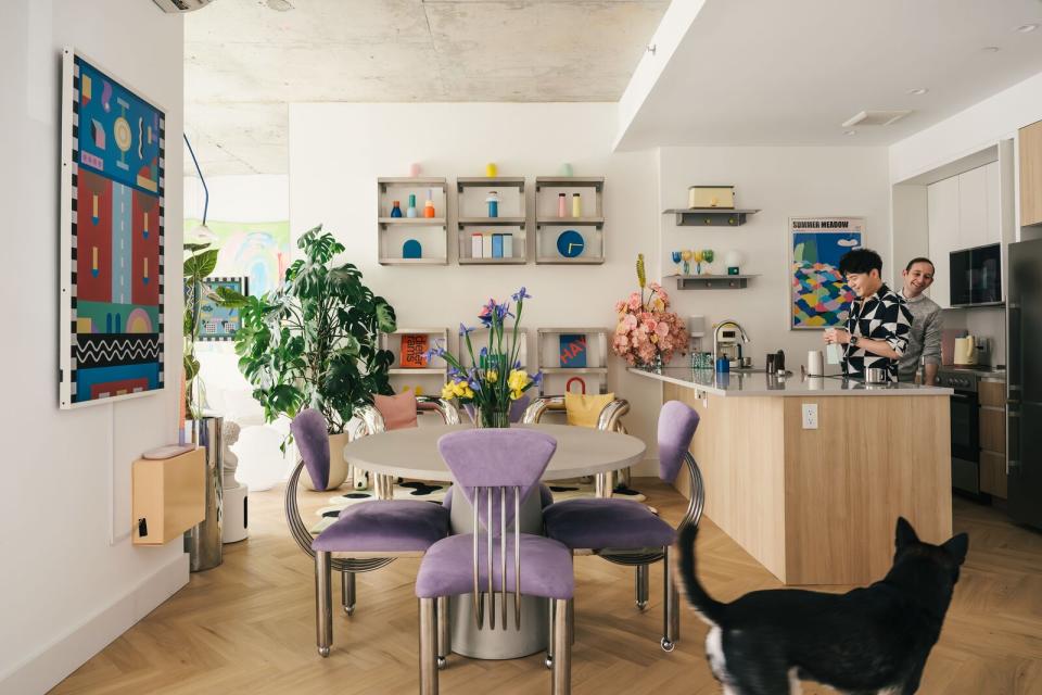 Mikei, his partner, and their dog Shabu Shabu in their living space. The table was made for the outdoors, but repurposed for the dining area from Urban Outfitters. It's surrounded by '80s-era vintage chairs sourced from Betsu. 