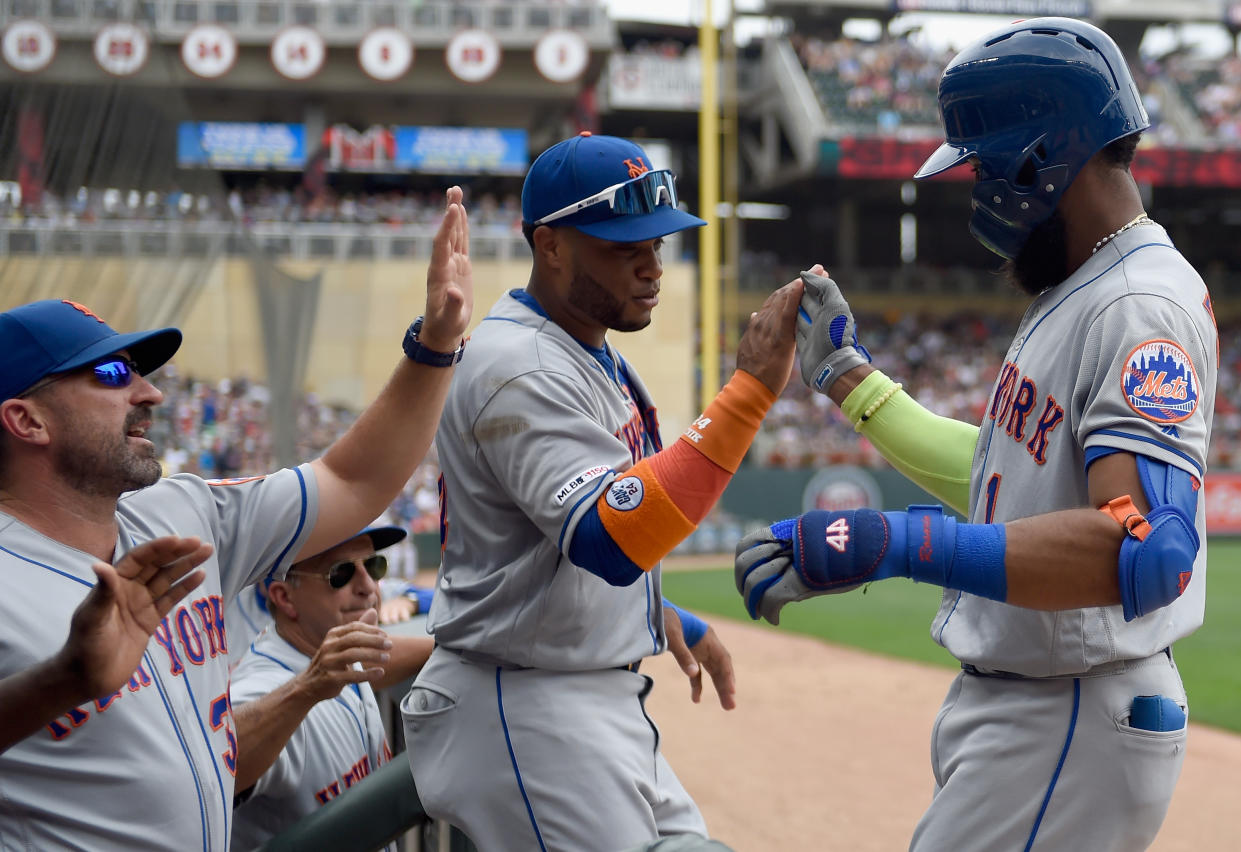 MINNEAPOLIS, MN - JULY 17: manager Mickey Callaway #36 and Robinson Cano #24 of the New York Mets congratulate Amed Rosario #1 on a solo home run against the Minnesota Twins during the third inning of the interleague game on July 17, 2019 at Target Field in Minneapolis, Minnesota. a(Photo by Hannah Foslien/Getty Images)