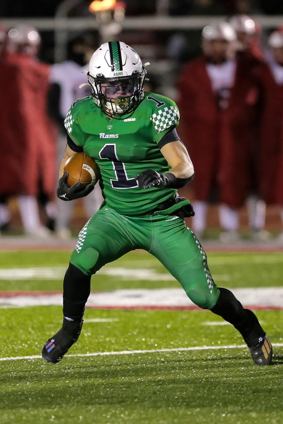 Badin's Carter Russo (1) hauls the mail as he looks for an open seam during a Division III regional final at Trotwood High School on Nov. 18, 2022.